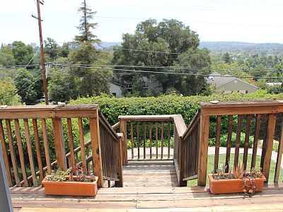 Deck Stairs To Fenced Backyard Below