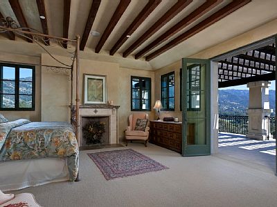 Master bedroom opens onto an outdoor deck with mountain and ocean views