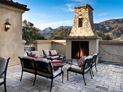 Outdoor courtyard with fireplace, next to the pool entertainment area